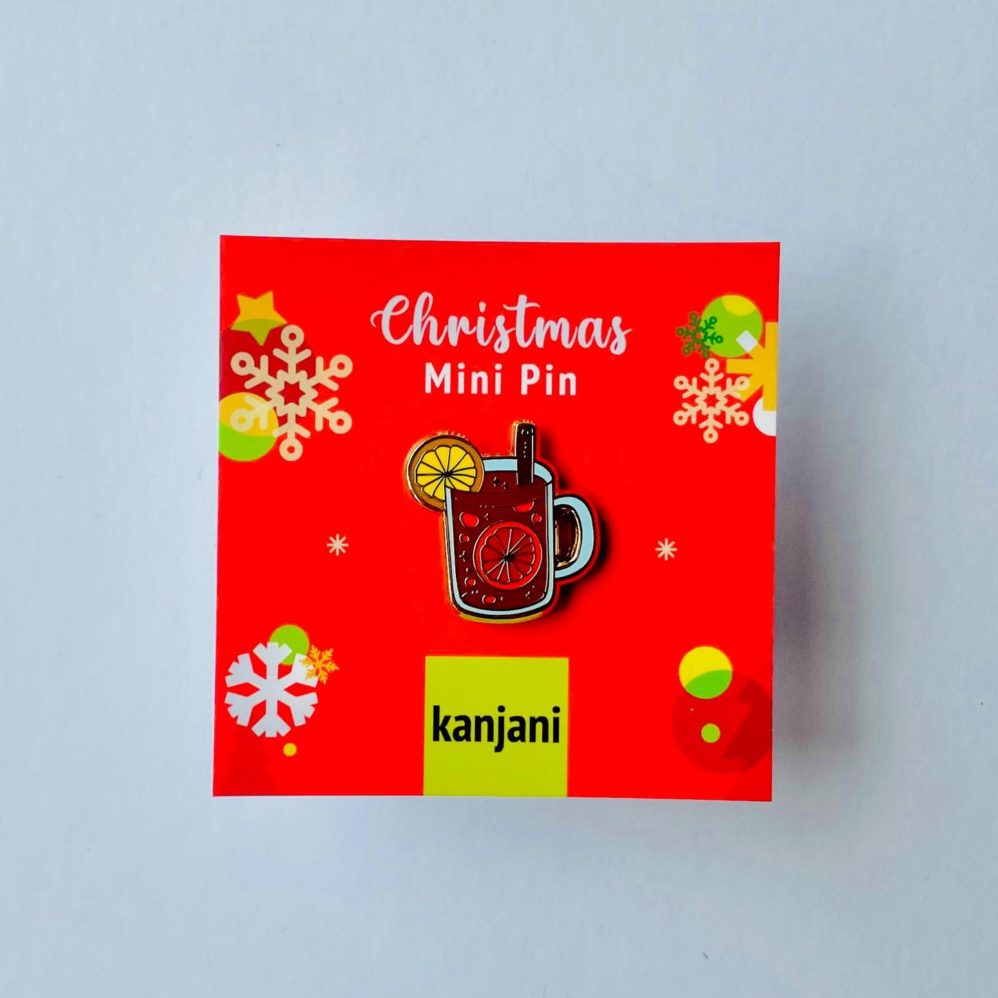 Red mulled wine mulled apple cider gluhwein in glass with orange and cinnamon gold hard enamel mini pin badge