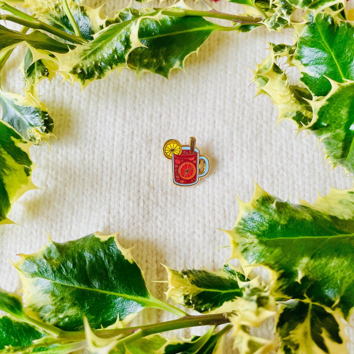 Red mulled wine mulled apple cider gluhwein in glass with orange and cinnamon gold hard enamel mini pin badge
