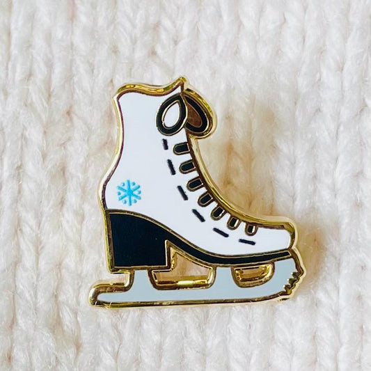 White and black ice skate with blue snowflake detail gold hard enamel mini pin
