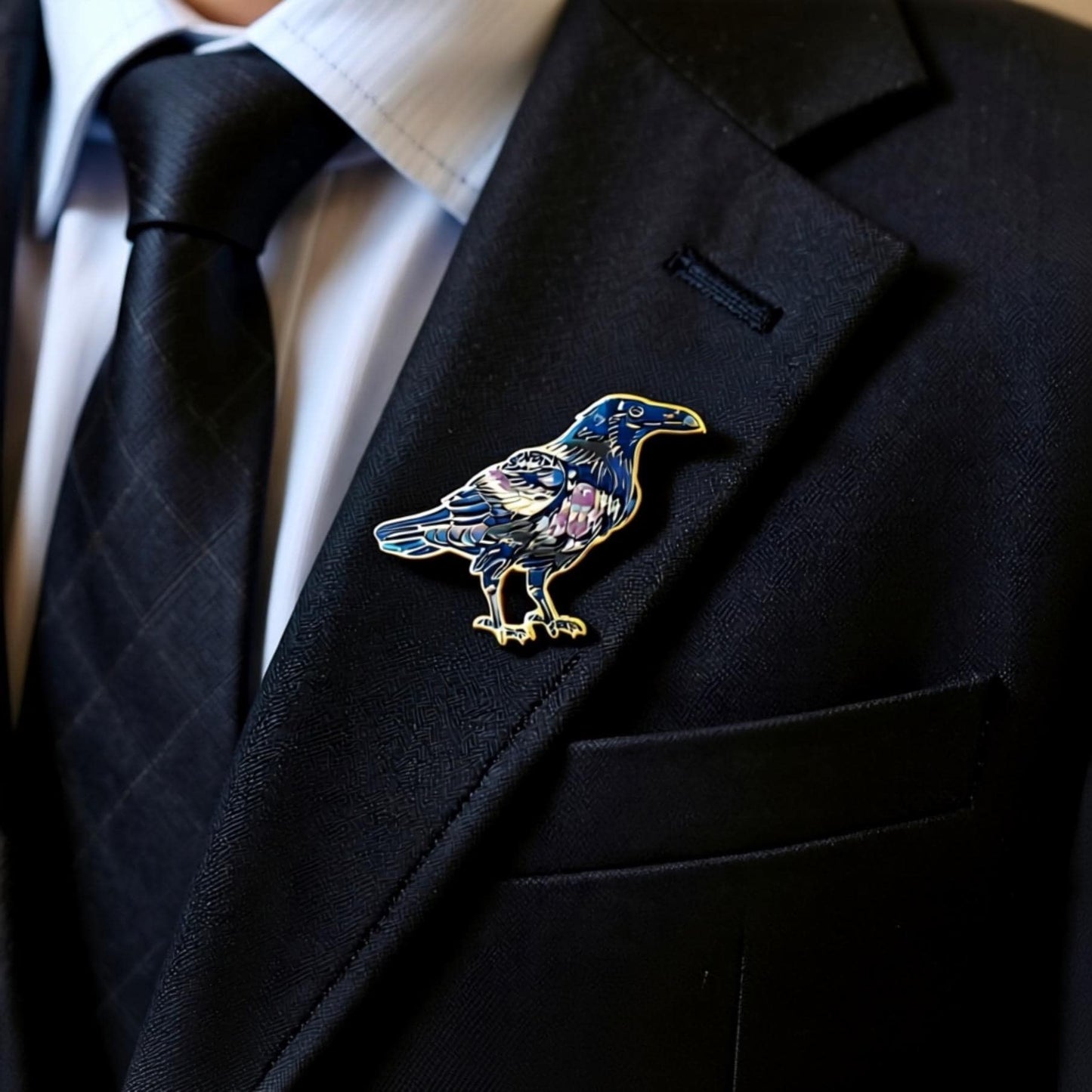 A close-up of a person wearing a black suit jacket with a decorative pin of a blue bird on the lapel.