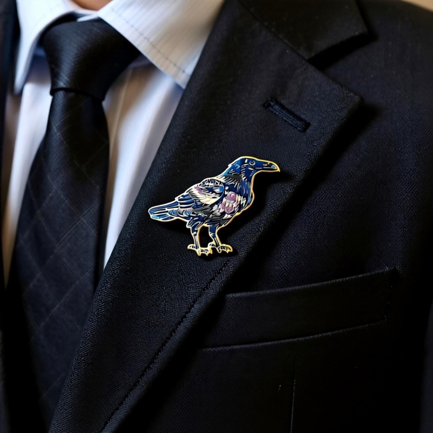 A close-up of a person wearing a black suit jacket with a decorative pin of a blue bird on the lapel.