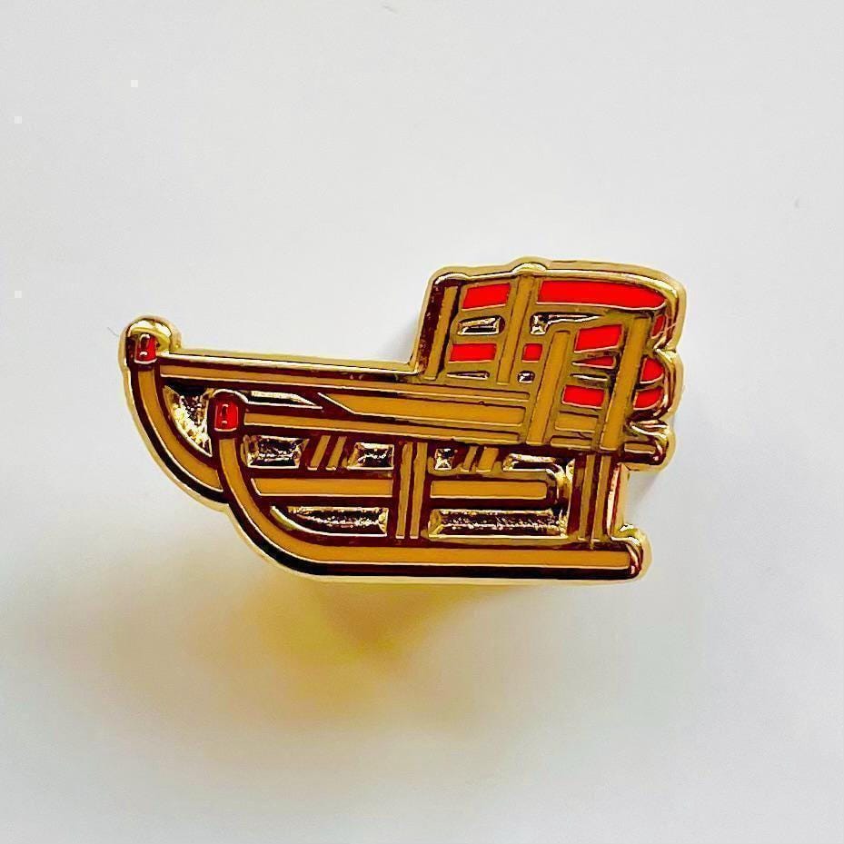 Sled enamel pin