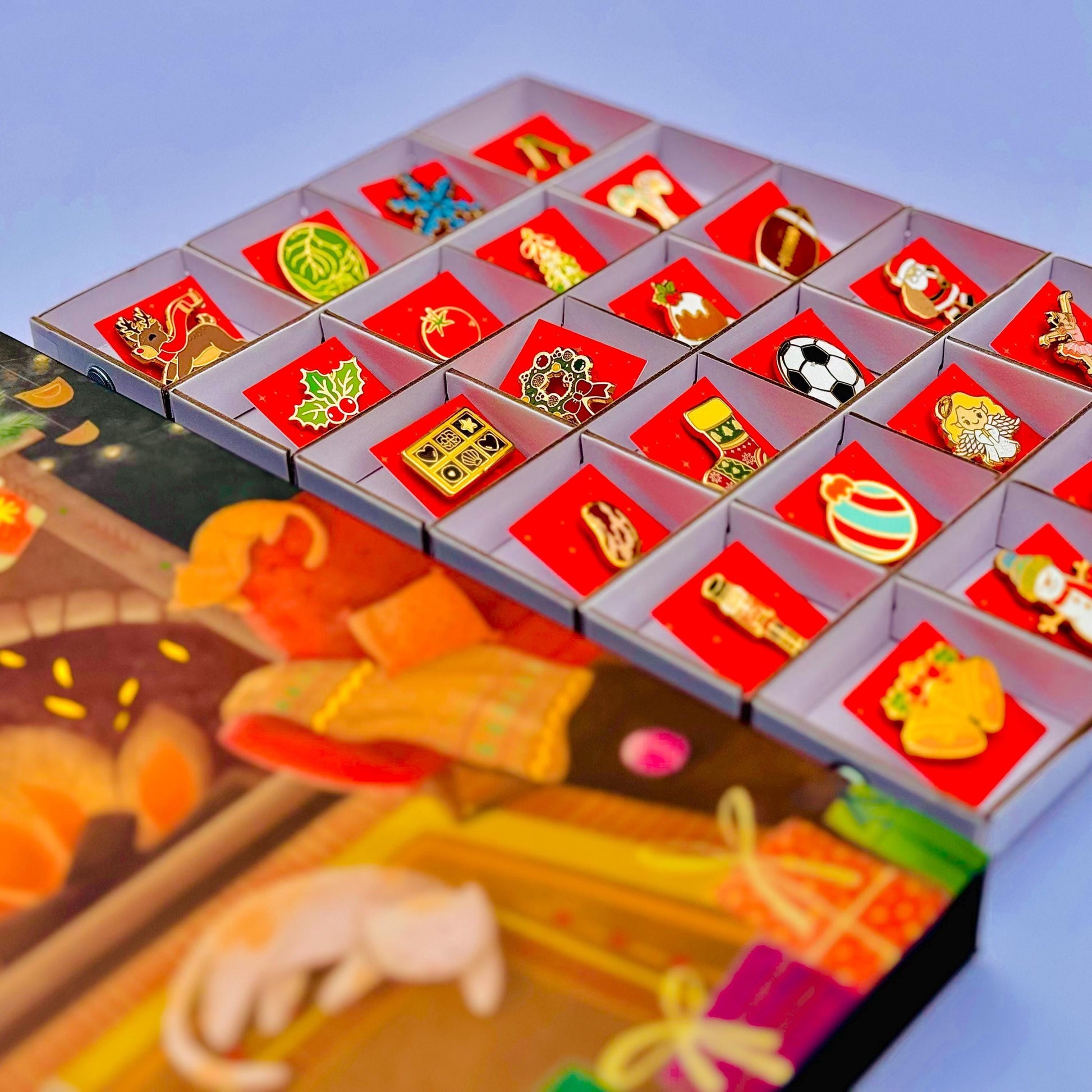 A collection of colorful pin badges displayed in a box, with a blurred background that appears to be a Christmas-themed illustration.