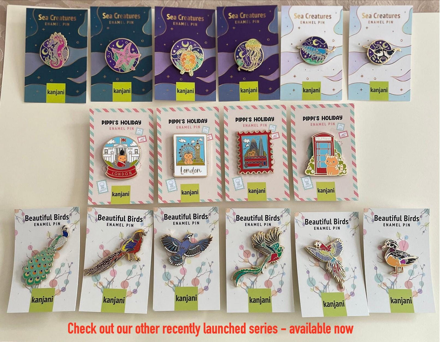 a collection of pins and badges featuring various sea creatures, including sea birds, sea creatures, and other marine life. The pins and badges are arranged in rows, showcasing the different designs and styles of the items.