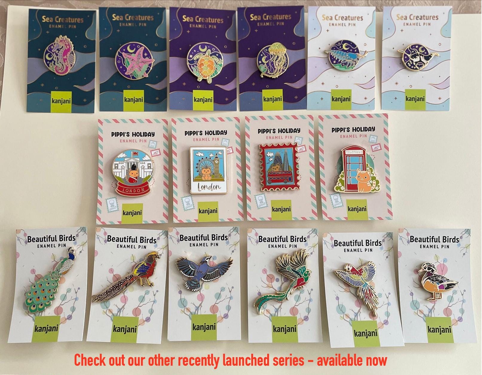 a collection of pins and badges featuring various sea creatures, including sea birds, sea creatures, and other marine life. The pins and badges are arranged in rows, showcasing the different designs and styles of the items.