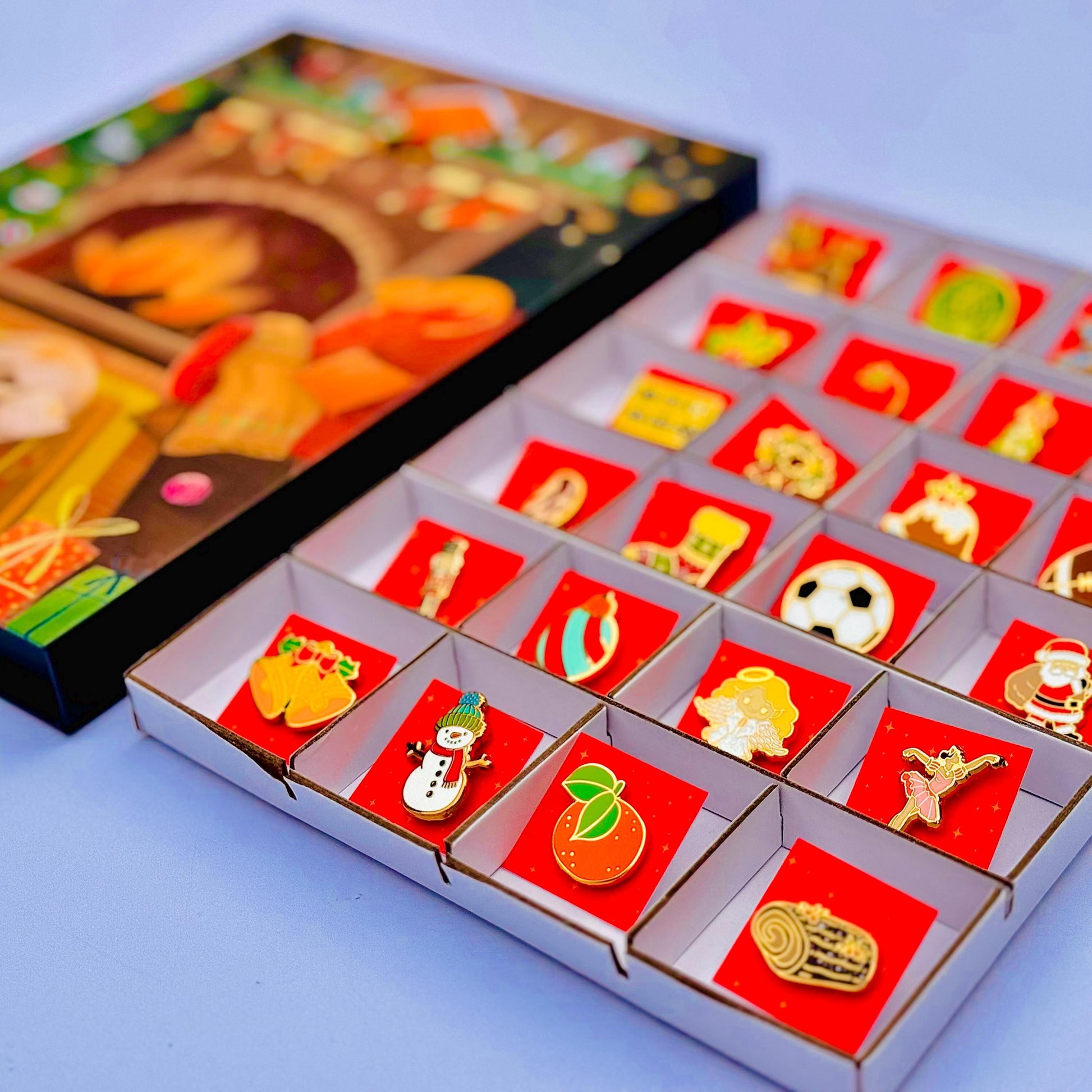 a collection of colorful pin badges displayed in a box, with a blurred background that appears to be a collage of various images.