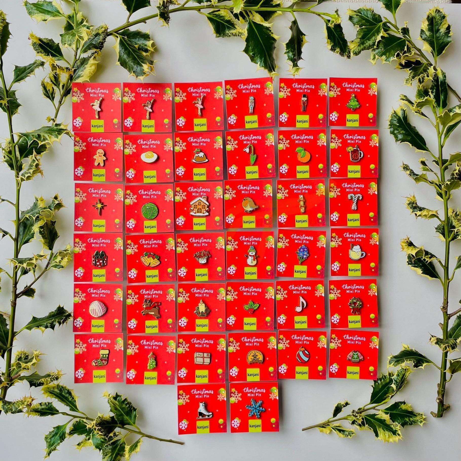 a collection of Christmas-themed pins arranged in a grid pattern on a white background. The pins are red and yellow, and each one has a unique design or symbol associated with the Christmas holiday season. The pins are surrounded by green leaves, creating a festive and holiday atmosphere.