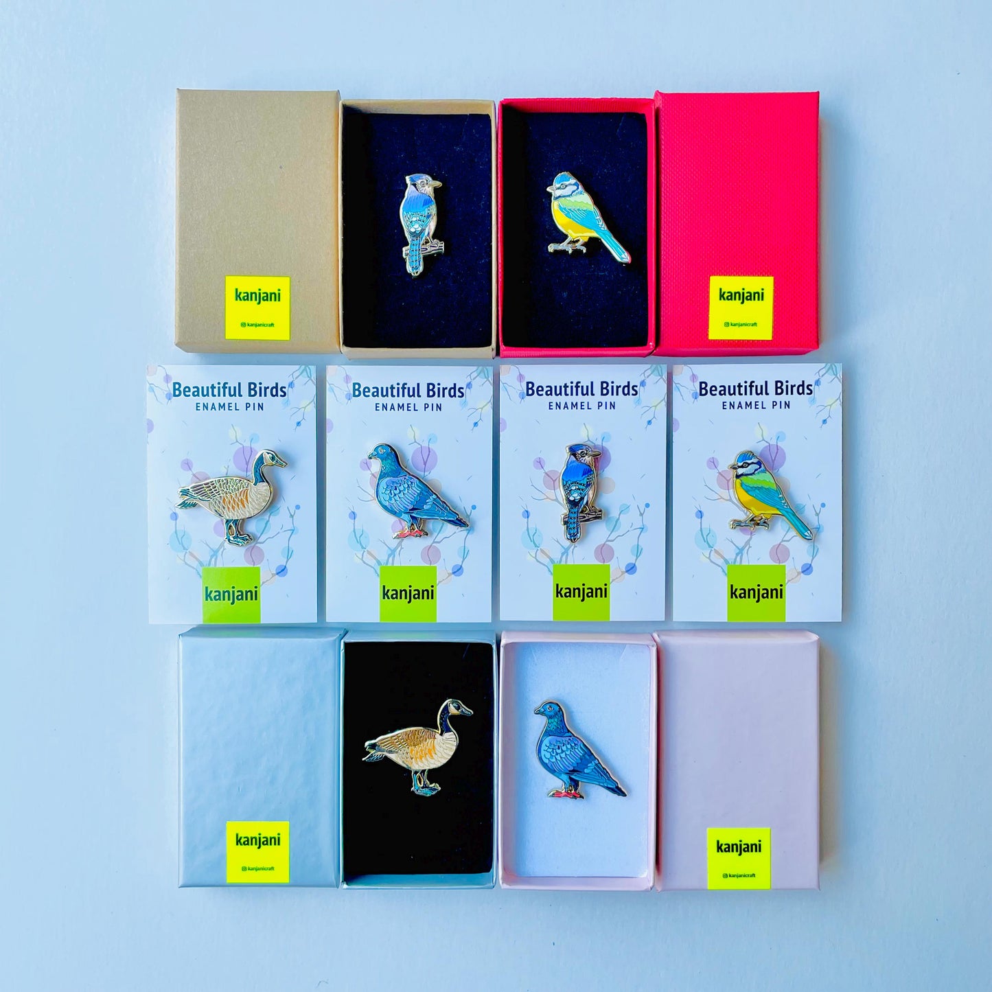 a collection of nine kanji pins, each with a unique bird design, arranged in two rows of three. The pins are presented in various colors and styles, showcasing the diversity of the kanji collection.