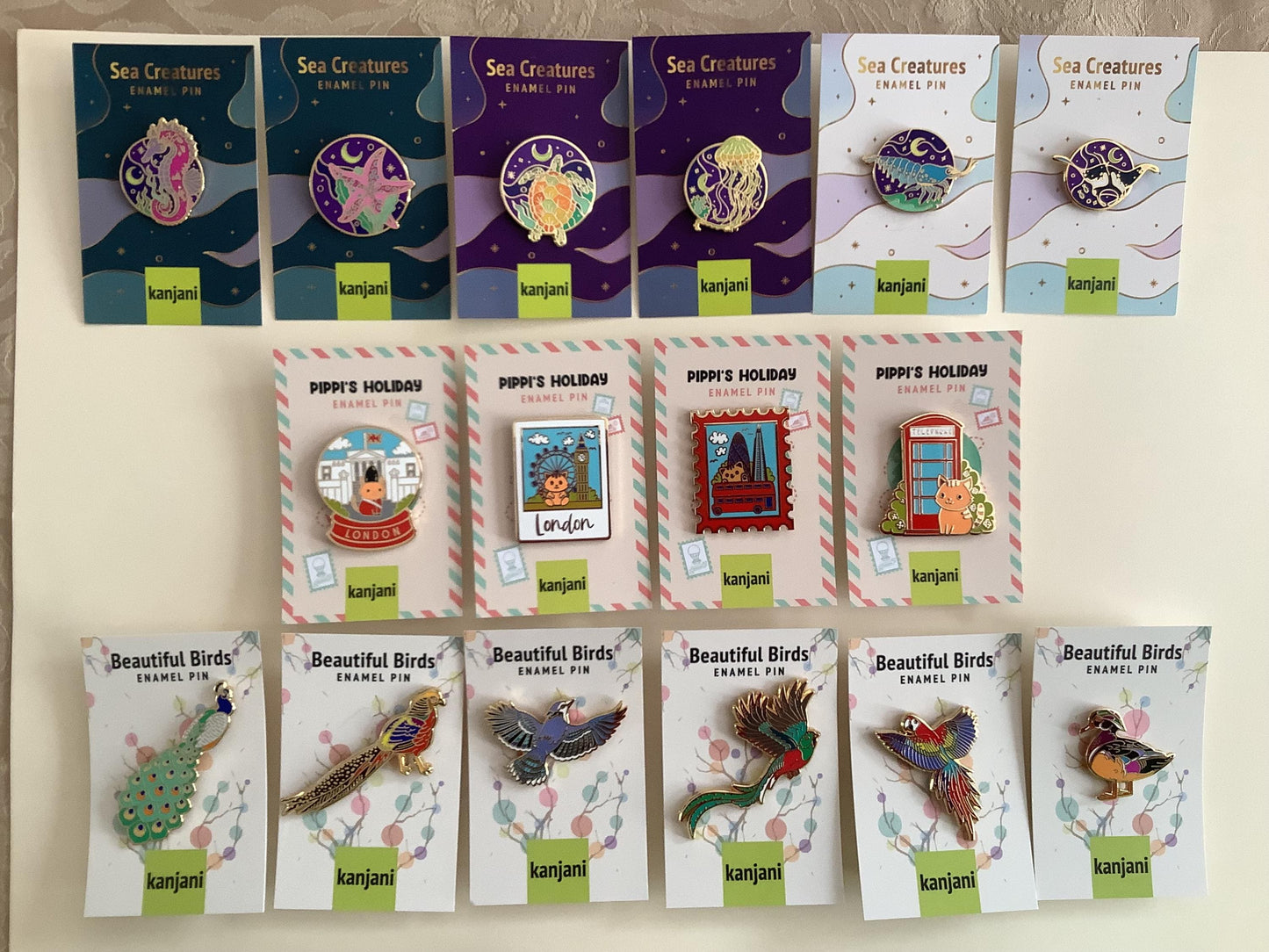 a collection of enamel pin designs featuring sea creatures and birds, including sea creatures, birds, and other marine life.